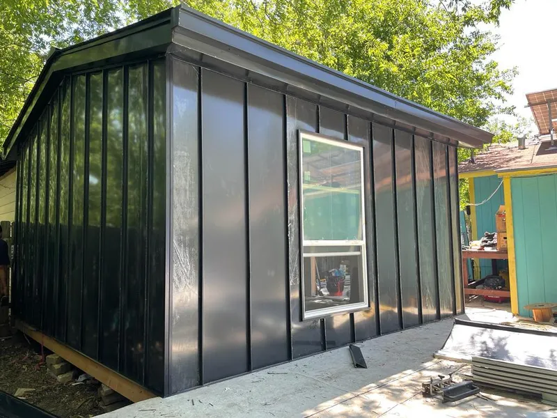 Black standing seam metal wall panels for Roof Inspection in Brush